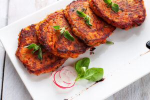 Homemade fried fish patties from canned salmon, sweet potato, eggs and chopped parsley